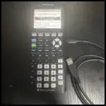 How to Recharge TI-84 Plus CE (Step-by-Step Guide) 1 TI-84 Plus CE calculator connected to a charging cable showing how to recharge the device properly